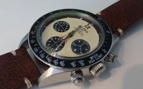 Close-up 4K Ultra HD image of a man-made wristwatch with a cream dial, black subdials, and brown leather strap on a light background.