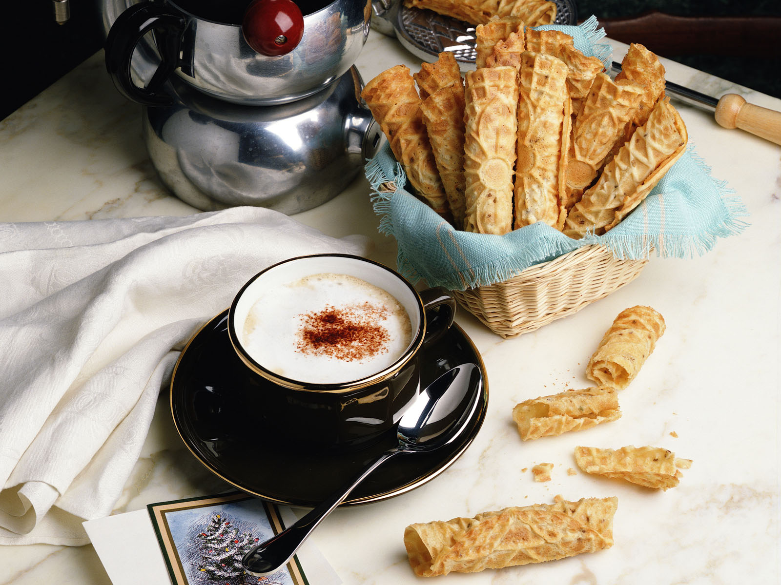 Italian-inspired dessert with a cup of cappuccino and pizzelles.