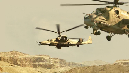 A striking HD image of military helicopters in flight, featuring the Kamov Ka-50 against a rugged landscape, showcasing their dynamic presence and power.