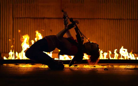 HD PC desktop wallpaper: music-themed image of a violinist arching backward while playing in front of a line of flames.