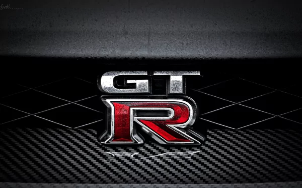 HD desktop wallpaper featuring the iconic GT-R emblem of a Nissan vehicle, set against a sleek, carbon fiber textured background.