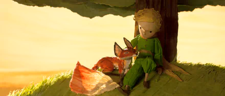 A scene from The Little Prince, featuring the titular character sitting under a tree with a fox, set against a warm, golden background. This HD wallpaper captures a moment of friendship.