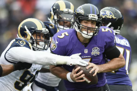 HD PC desktop wallpaper of Baltimore Ravens players: a quarterback clutching the ball as defenders converge in intense NFL sports action, team colors filling the dynamic background.
