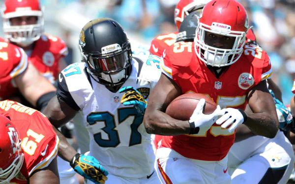HD PC desktop wallpaper background featuring a Kansas City Chiefs running back powering through a defender in an action sports football shot.