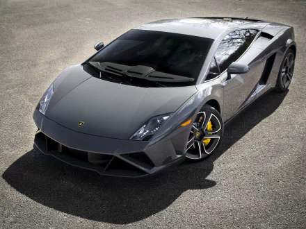 High-definition PC desktop wallpaper featuring a sleek grey Lamborghini Gallardo LP560-4 sports car parked on asphalt, showcasing its sharp design and luxury vehicle appeal.