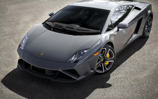 High-definition PC desktop wallpaper featuring a sleek grey Lamborghini Gallardo LP560-4 sports car parked on asphalt, showcasing its sharp design and luxury vehicle appeal.