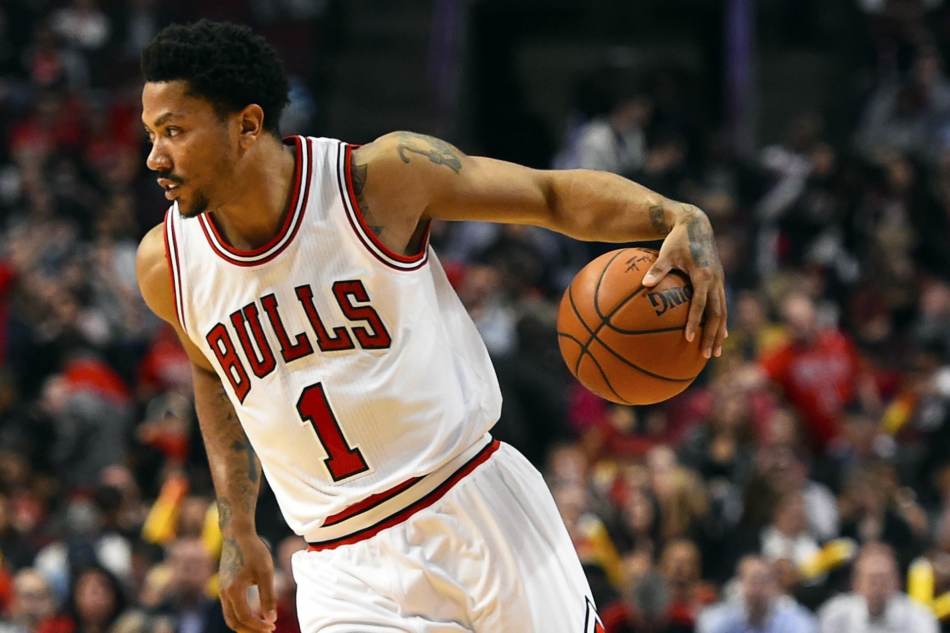 HD PC desktop wallpaper featuring a Chicago Bulls player dribbling a basketball during a game, capturing the intensity of the sport.