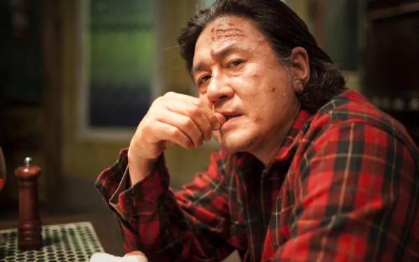 HD PC desktop wallpaper featuring a close-up of a man in a red plaid shirt from the movie I Saw The Devil, showcasing a tense and dramatic atmosphere.