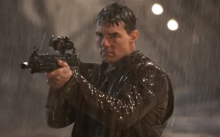 HD desktop wallpaper featuring Tom Cruise as Jack Reacher aiming a firearm in the rain, capturing an intense movie scene.