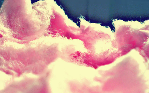 Close-up of pink cotton candy with soft, fluffy texture, captured in vibrant HD detail for a colorful PC desktop wallpaper and background.
