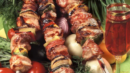 HD desktop wallpaper featuring juicy shashlik skewers grilled to perfection with fresh vegetables and a glass of beverage, showcasing delicious barbecue meat.