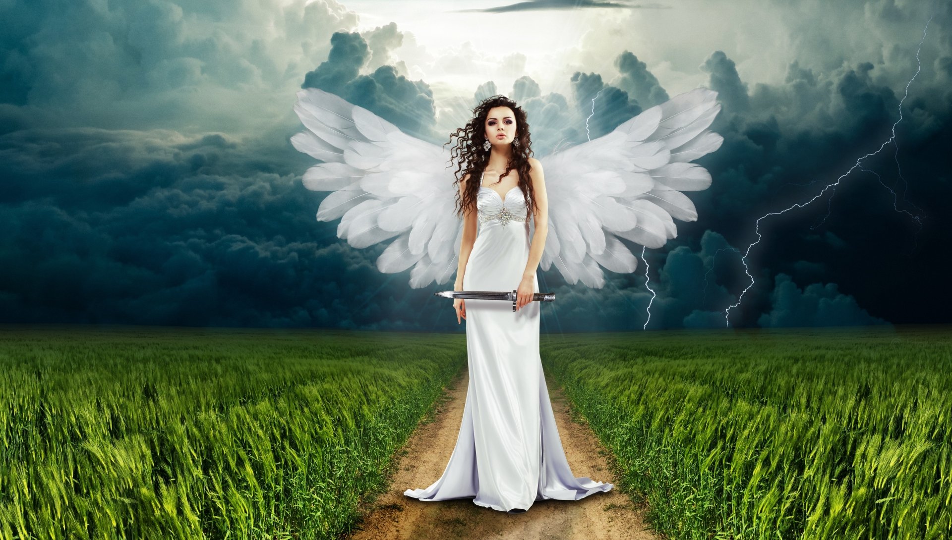 A fantasy scene featuring an angel with long hair and large wings, standing in a vibrant green field under a dramatic stormy sky. A striking 4K Ultra HD desktop wallpaper.