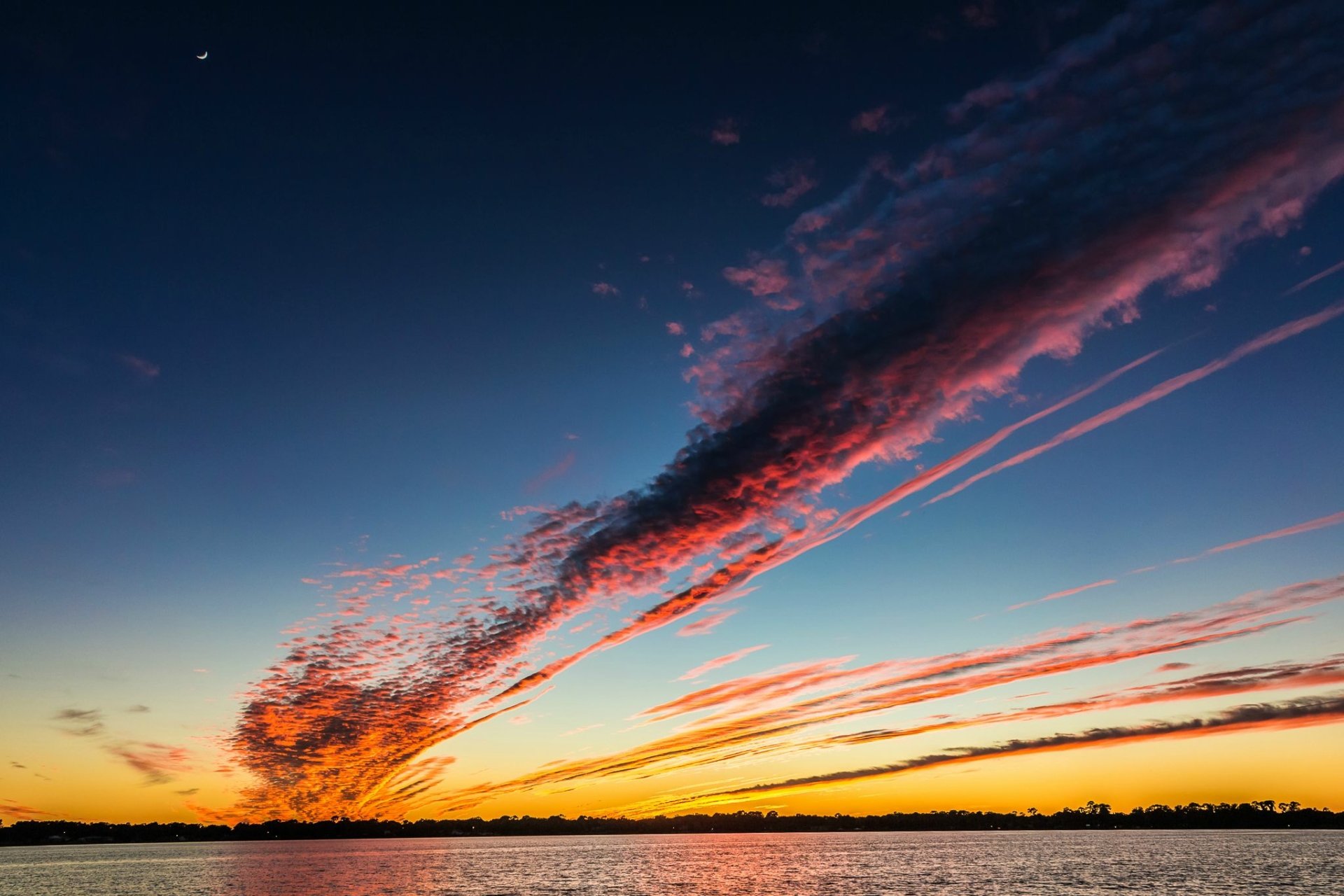 HD PC desktop wallpaper: dramatic streaks of pink-orange clouds across a twilight sky above a calm lake, nature scene.