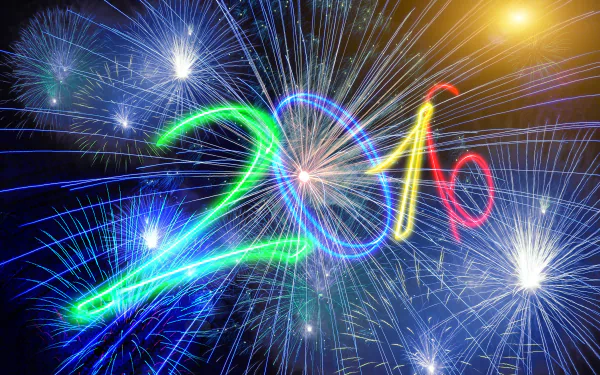 4K Ultra HD PC desktop wallpaper: colorful fireworks burst around glowing '2016' script celebrating New Year holiday.