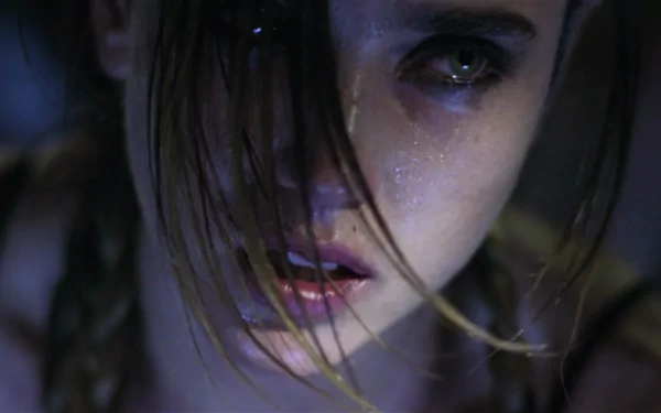 Close-up of Jennifer Connelly from the movie Requiem for a Dream, featured as an HD PC desktop wallpaper.