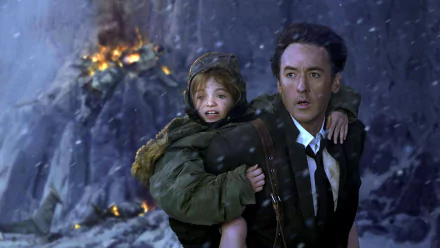 HD PC desktop wallpaper featuring a dramatic scene from the 2012 movie, showing a man carrying a child amidst a fiery, rocky backdrop.