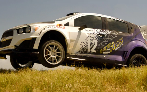 A dynamic HD wallpaper featuring a race car from the movie Transformers: Age of Extinction, showcasing its vibrant design against a grassy backdrop.