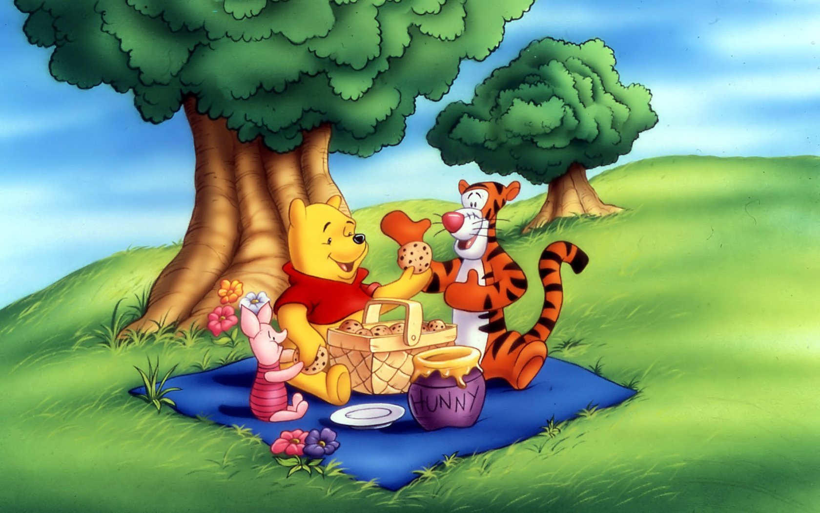 Group of friends having a picnic with Piglet and Tiger from Winnie The Pooh