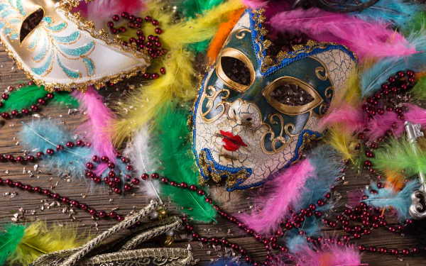 Colorful feathers and intricate masks are artfully arranged in this vibrant carnival-themed 4K Ultra HD wallpaper, capturing the festive spirit of celebration.