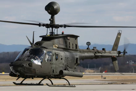 Military Bell OH-58 Kiowa helicopter on the ground with clear sky, captured as an HD PC desktop wallpaper background.