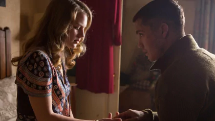 A close-up scene from the movie Fury featuring Alicia Von Rittberg and Logan Lerman, capturing an intimate moment between their characters in a warm, detailed setting.