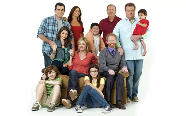 HD PC desktop wallpaper/background of TV show Modern Family: smiling multi‑generation family posed against a clean white backdrop.