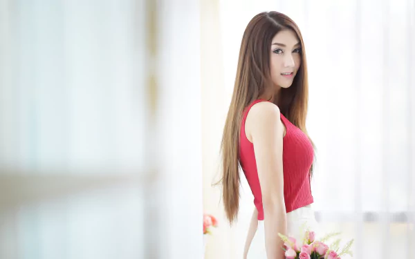 HD desktop wallpaper featuring an Asian brunette woman, wearing a red top, holding flowers in soft bokeh background.