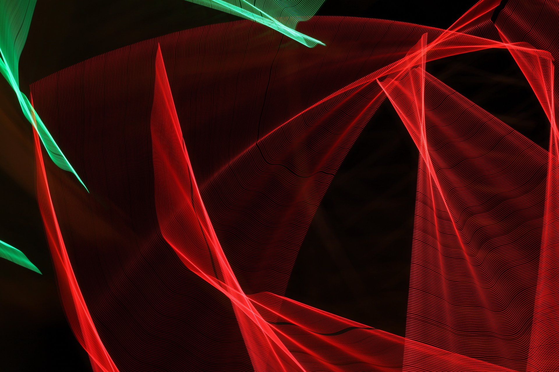 Abstract red and green lines and angular shapes on a dark field, 2K Quad HD PC desktop wallpaper and background.
