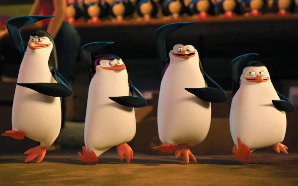 HD PC desktop wallpaper featuring the four penguins from the movie Penguins of Madagascar striking confident poses in a lively scene.
