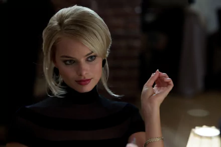 Margot Robbie as Naomi Lapaglia in a scene from the movie The Wolf of Wall Street. The image serves as a stylish HD desktop wallpaper, capturing her captivating presence.