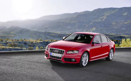 HD desktop wallpaper featuring a red Audi S4 parked on a road with mountainous landscape in the background, showcasing the sleek design of the Audi vehicle.