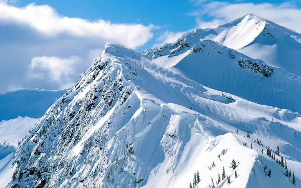 HD desktop wallpaper of a snowy mountain peak under a clear blue sky, showcasing the beauty of nature in winter.