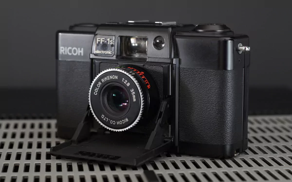  The Ricoh FF-1 is a scale-focusing, programmed exposure camera.