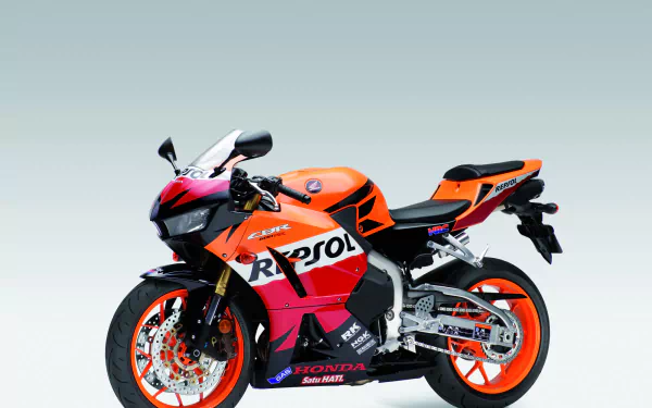 Repsol-liveried Honda CBR600RR sport motorcycle vehicle on a pale gradient backdrop — HD PC desktop wallpaper and background.
