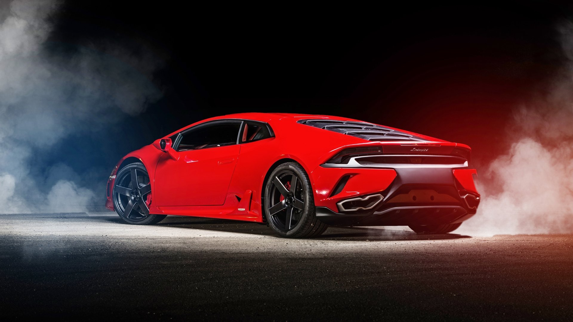 Red Lamborghini Huracan on smoky asphalt with dramatic red and blue lighting — 4K Ultra HD PC desktop wallpaper background, rear three-quarter view.