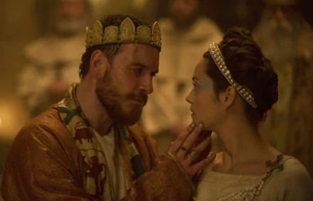 5K Ultra HD PC desktop wallpaper: film still from Macbeth — Macbeth and Lady Macbeth in royal robes and crowns, he cups her chin as they share a tense, candlelit gaze.