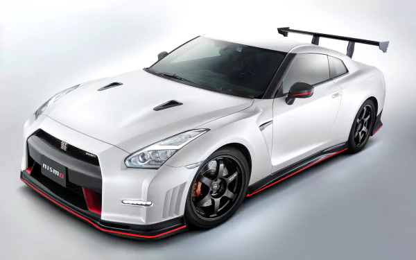 White Nissan GT-R Nismo supercar in three-quarter front view on a light background — 2K Quad HD PC desktop wallpaper of the high-performance vehicle.