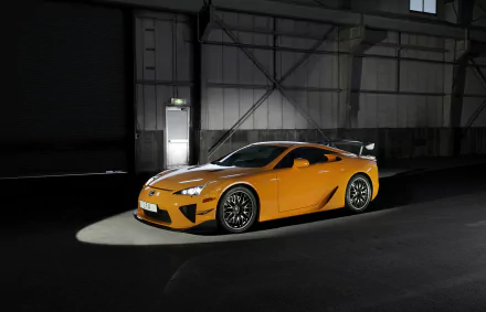 HD desktop wallpaper featuring a sleek yellow Lexus LFA supercar parked inside a dimly lit industrial space, showcasing its dynamic design and bold presence.
