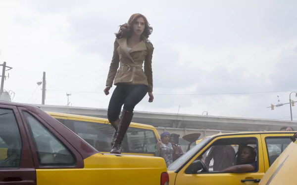 Natasha Romanoff, also known as Black Widow, portrayed by Scarlett Johansson, navigates a chaotic traffic scene in this dynamic HD wallpaper from *Captain America: Civil War*.