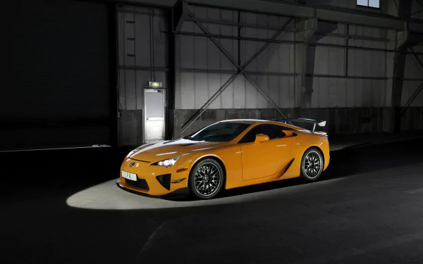 HD desktop wallpaper featuring a sleek yellow Lexus LFA supercar parked inside a dimly lit industrial space, showcasing its dynamic design and bold presence.