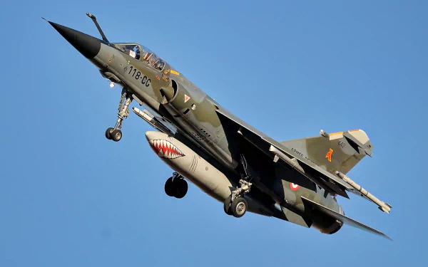 Dassault Mirage F1 jet fighter warplane in flight against a clear blue sky, captured as an HD military aircraft desktop wallpaper and background.