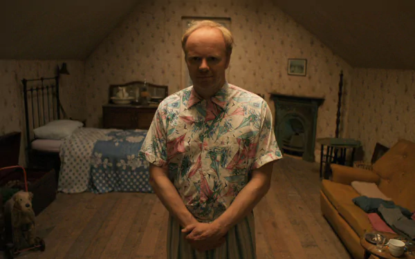 William Herrick from the TV show Being Human stands in a dimly lit attic bedroom with vintage decor, captured in an HD PC desktop wallpaper and background.