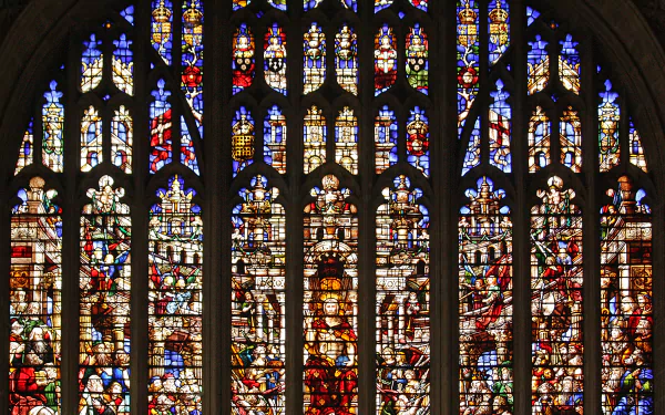 Colorful cathedral church stained-glass window showing religious scenes; high-detail photography as a 2K Quad HD PC desktop wallpaper/background.