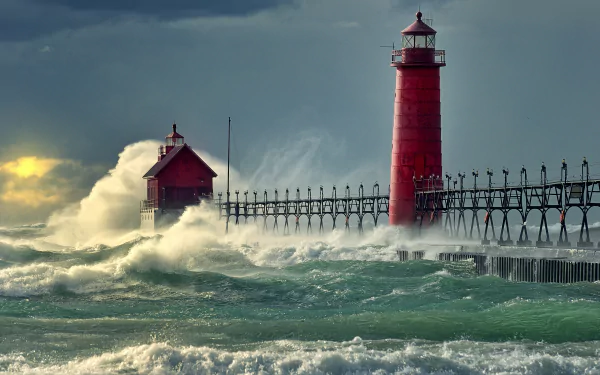 A striking HD image of a red lighthouse standing tall on a pier, surrounded by powerful waves of the Michigan ocean, capturing nature's beauty and man-made structures.