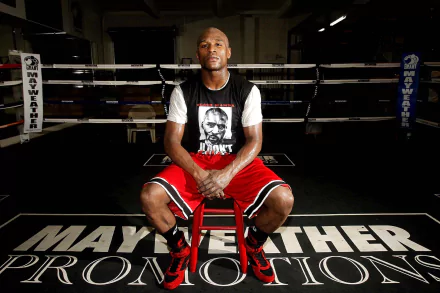 HD desktop wallpaper of Floyd Mayweather sitting in a boxing ring, with Mayweather Promotions visible on the canvas.