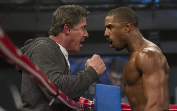 HD desktop wallpaper featuring Sylvester Stallone as Rocky Balboa and Michael B. Jordan as Adonis Creed in an intense scene from the movie Creed.
