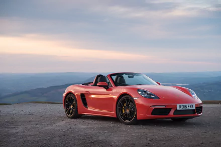 Red Porsche Boxster sports car parked on a scenic overlook, captured in stunning 4K Ultra HD for a vibrant PC desktop wallpaper background.