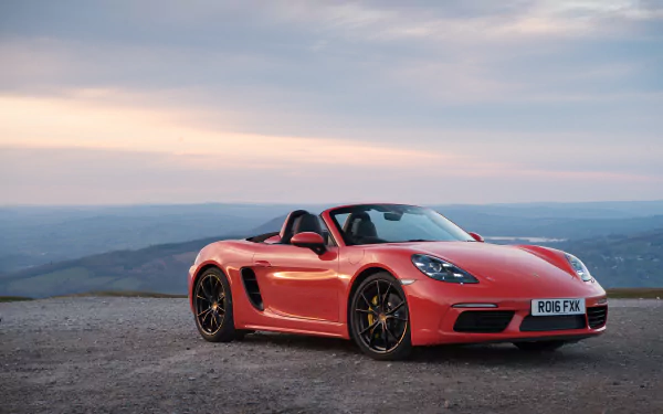 Red Porsche Boxster sports car parked on a scenic overlook, captured in stunning 4K Ultra HD for a vibrant PC desktop wallpaper background.