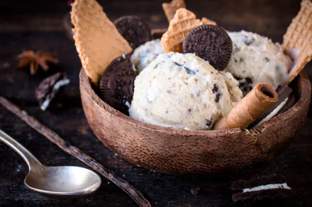 A 4K Ultra HD desktop wallpaper featuring a bowl of summer food: scoops of cookies and cream ice cream with waffle cones and cookie pieces.