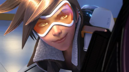 HD desktop wallpaper featuring Tracer from the video game Overwatch, showcasing her signature confident smile and goggles.
